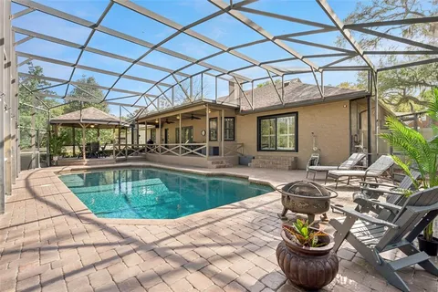 a view of a swimming pool with outdoor seating