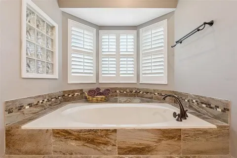 a bathroom with a granite countertop sink toilet mirror vanity and shower