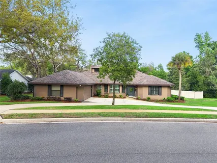 a front view of a house with a garden and yard
