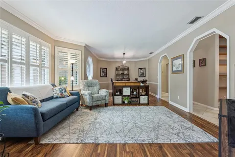 a living room with furniture a fireplace and a table