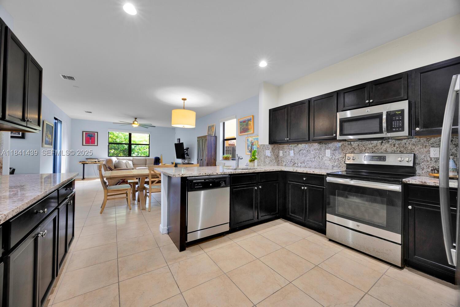 455 Southeast 34th Terrace Homestead, FL 33033 - Photo 13 of 40 Beautiful open kitchen with stainless steel appliances and lots of storage!