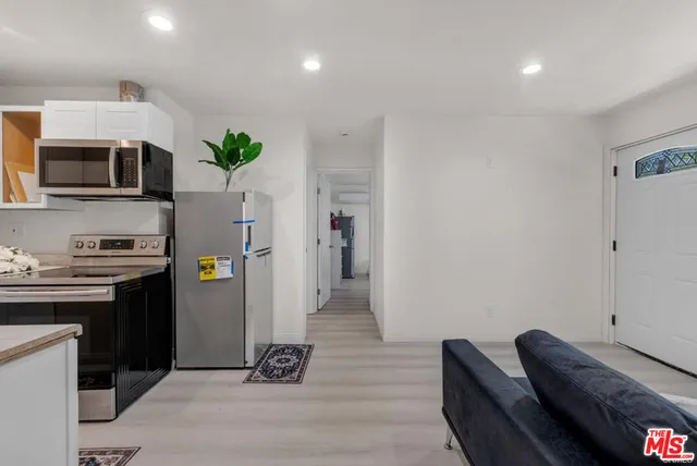 a kitchen with stainless steel appliances a refrigerator sink and stove