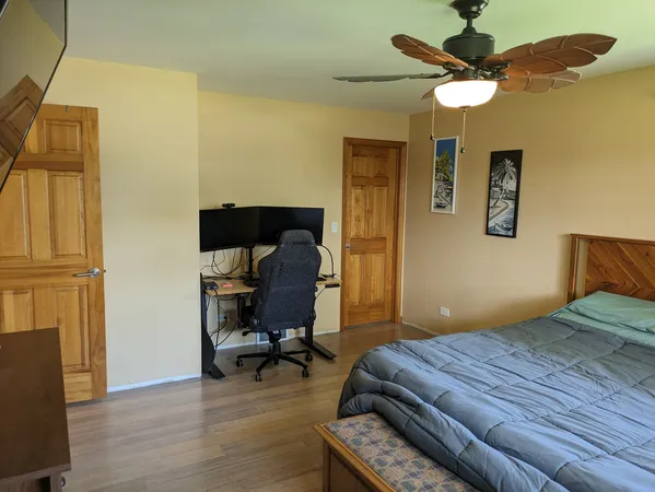 a bedroom with a bed and a chandelier