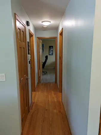 a view of hallway with wooden floor