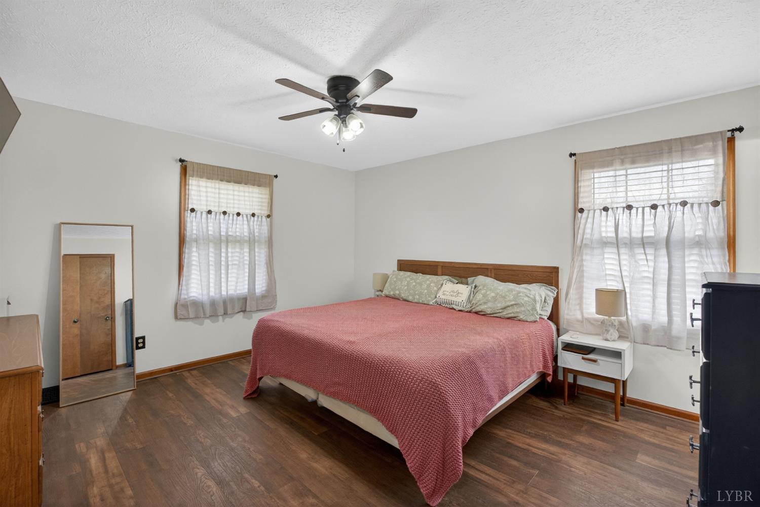 1002 Homeplace Road Rustburg, VA 24588 - Photo 24 of 48 a bedroom with a bed and wooden floor