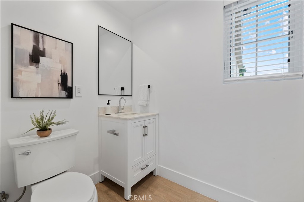 5248 Segals Way Sherman Oaks, CA 91411 - Photo 13 of 37 a bathroom with a toilet a sink and mirror