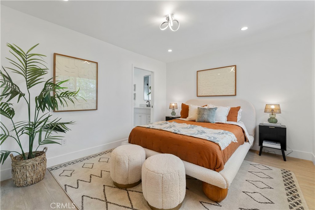 5248 Segals Way Sherman Oaks, CA 91411 - Photo 21 of 37 a bedroom with a large bed and a potted plant