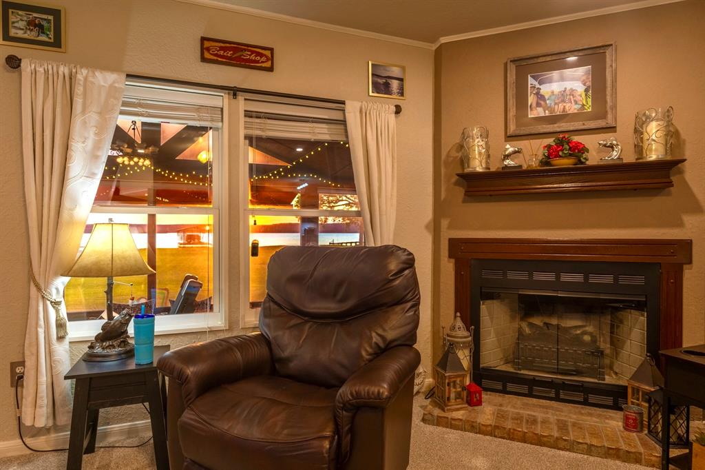 1167 Willow Road Graford, TX 76449 - Photo 11 of 33 a living room with furniture and a fireplace