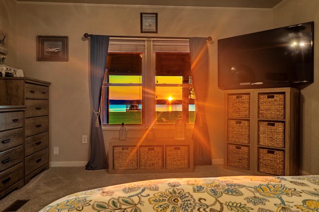 1167 Willow Road Graford, TX 76449 - Photo 18 of 33 a bedroom with a bed and a television