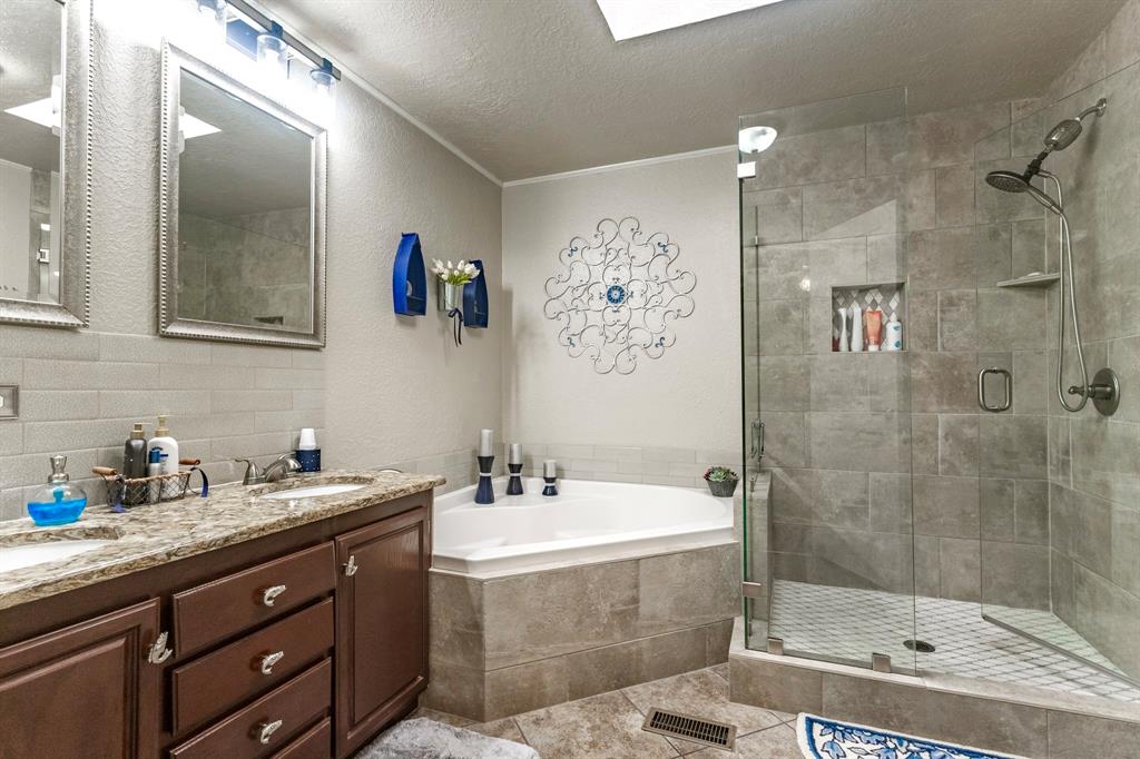 1167 Willow Road Graford, TX 76449 - Photo 19 of 33 a bathroom with a tub sink and mirror