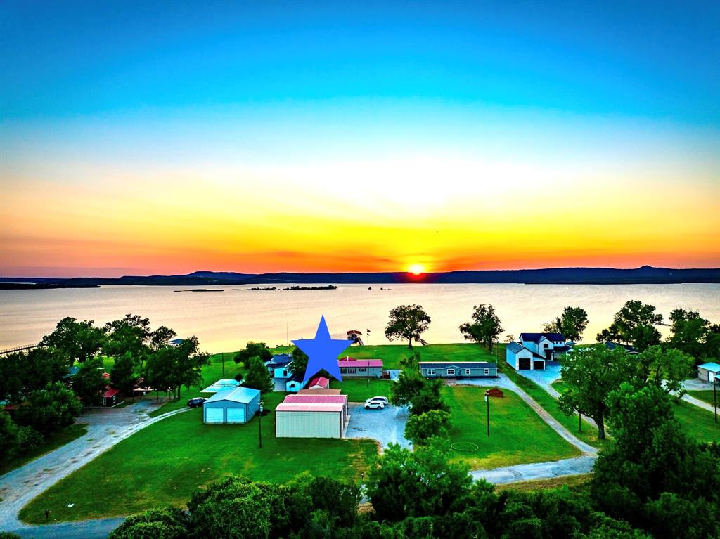 1167 Willow Road Graford, TX 76449 - Photo 32 of 33 a view of a lake with couches and city view