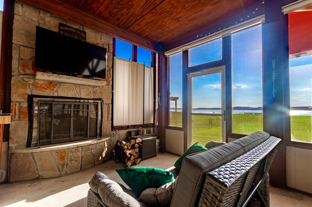 1167 Willow Road Graford, TX 76449 - Photo 6 of 33 a balcony with furniture and a fireplace