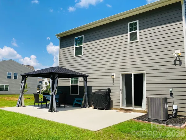 a view of a house with deck and a yard