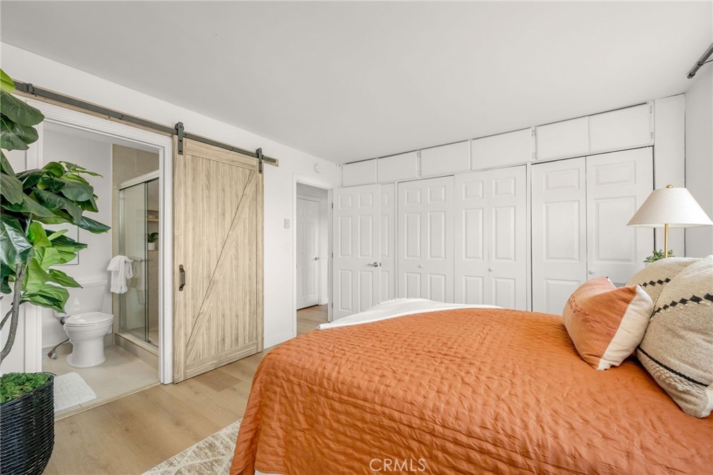 2844 East 3rd Street, Unit 210 Long Beach, CA 90814 - Photo 16 of 23 a bedroom with a bed and a potted plant