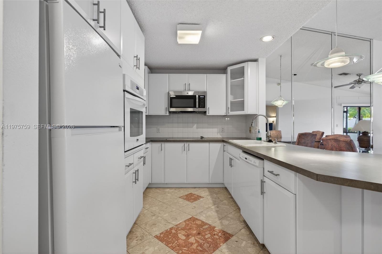 6708 North Pine Island Road Tamarac, FL 33321 - Photo 11 of 40 a kitchen with kitchen island a sink stainless steel appliances and cabinets