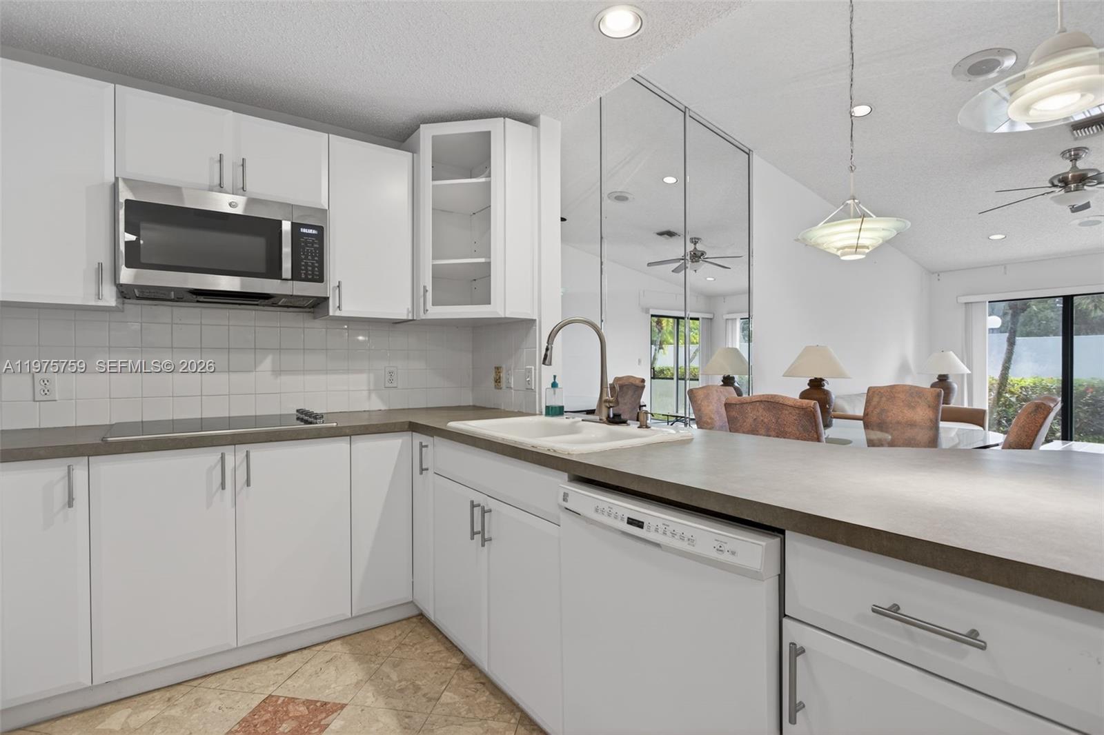 6708 North Pine Island Road Tamarac, FL 33321 - Photo 13 of 40 a kitchen with appliances a sink and cabinets