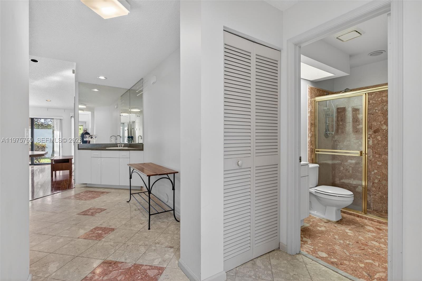 6708 North Pine Island Road Tamarac, FL 33321 - Photo 15 of 40 a bathroom with a toilet sink and a mirror