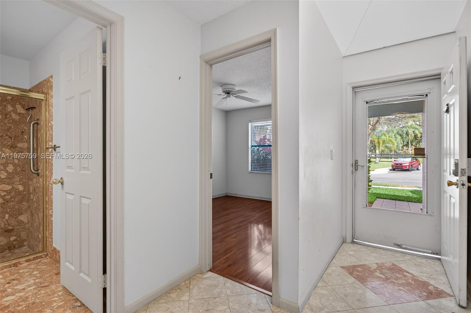 6708 North Pine Island Road Tamarac, FL 33321 - Photo 16 of 40 a view of hallway with wooden floor and a livingroom