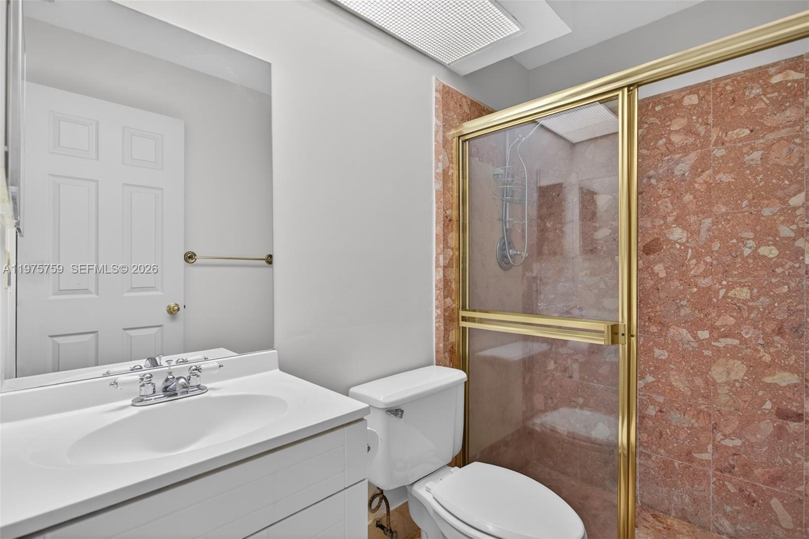 6708 North Pine Island Road Tamarac, FL 33321 - Photo 19 of 40 a bathroom with a sink mirror vanity and toilet