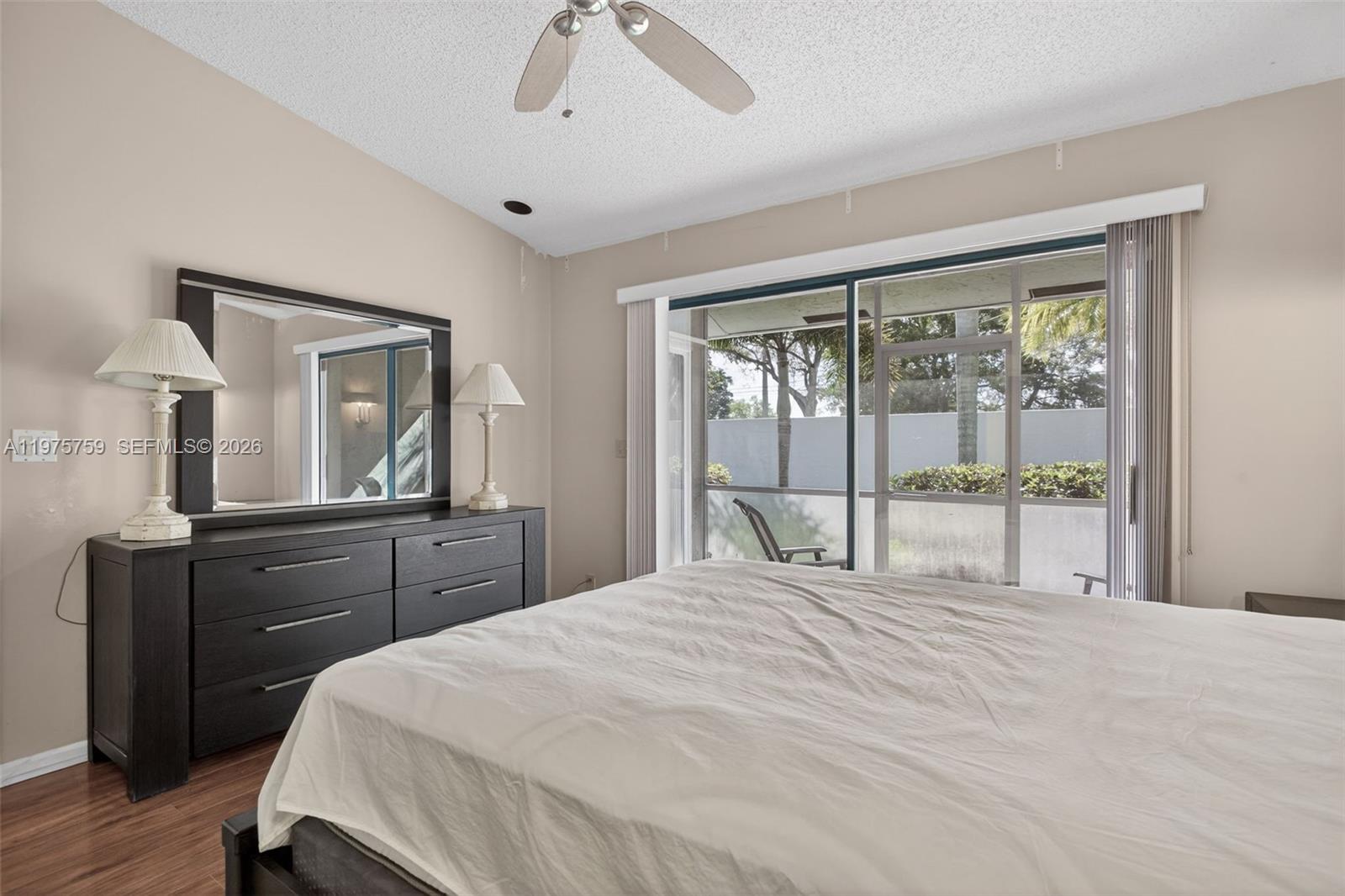 6708 North Pine Island Road Tamarac, FL 33321 - Photo 22 of 40 a bedroom with a large bed and a window