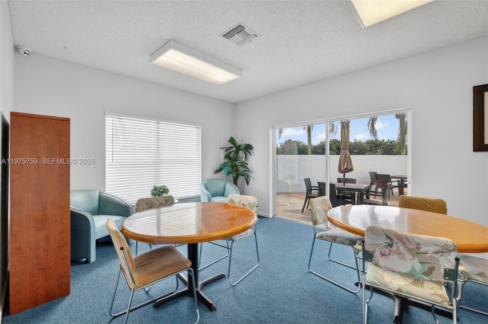 6708 North Pine Island Road Tamarac, FL 33321 - Photo 34 of 40 a living room with furniture a window and a table