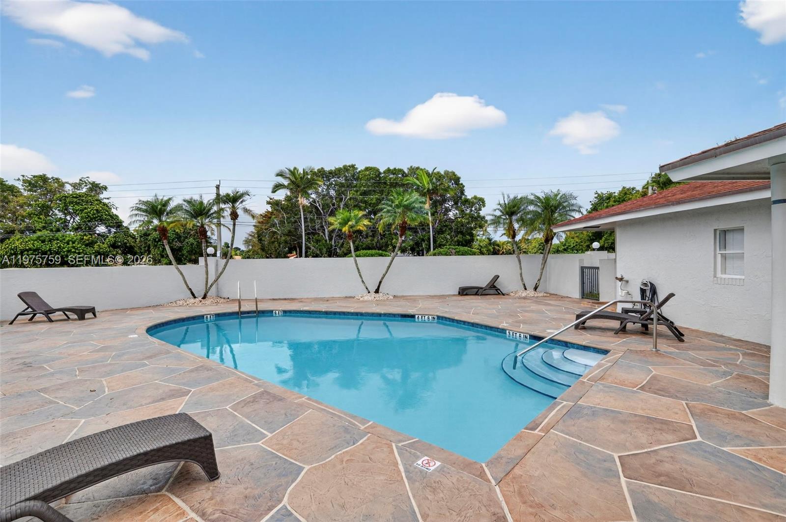 6708 North Pine Island Road Tamarac, FL 33321 - Photo 38 of 40 a view of a swimming pool with lounge chairs