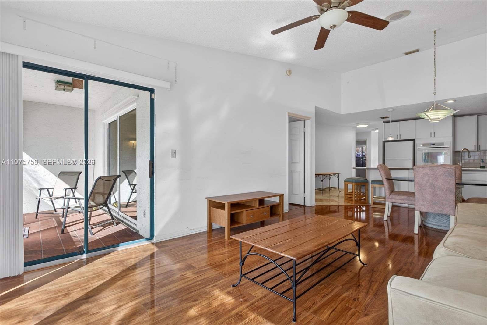 6708 North Pine Island Road Tamarac, FL 33321 - Photo 5 of 40 a living room with furniture a dining table and a piano table