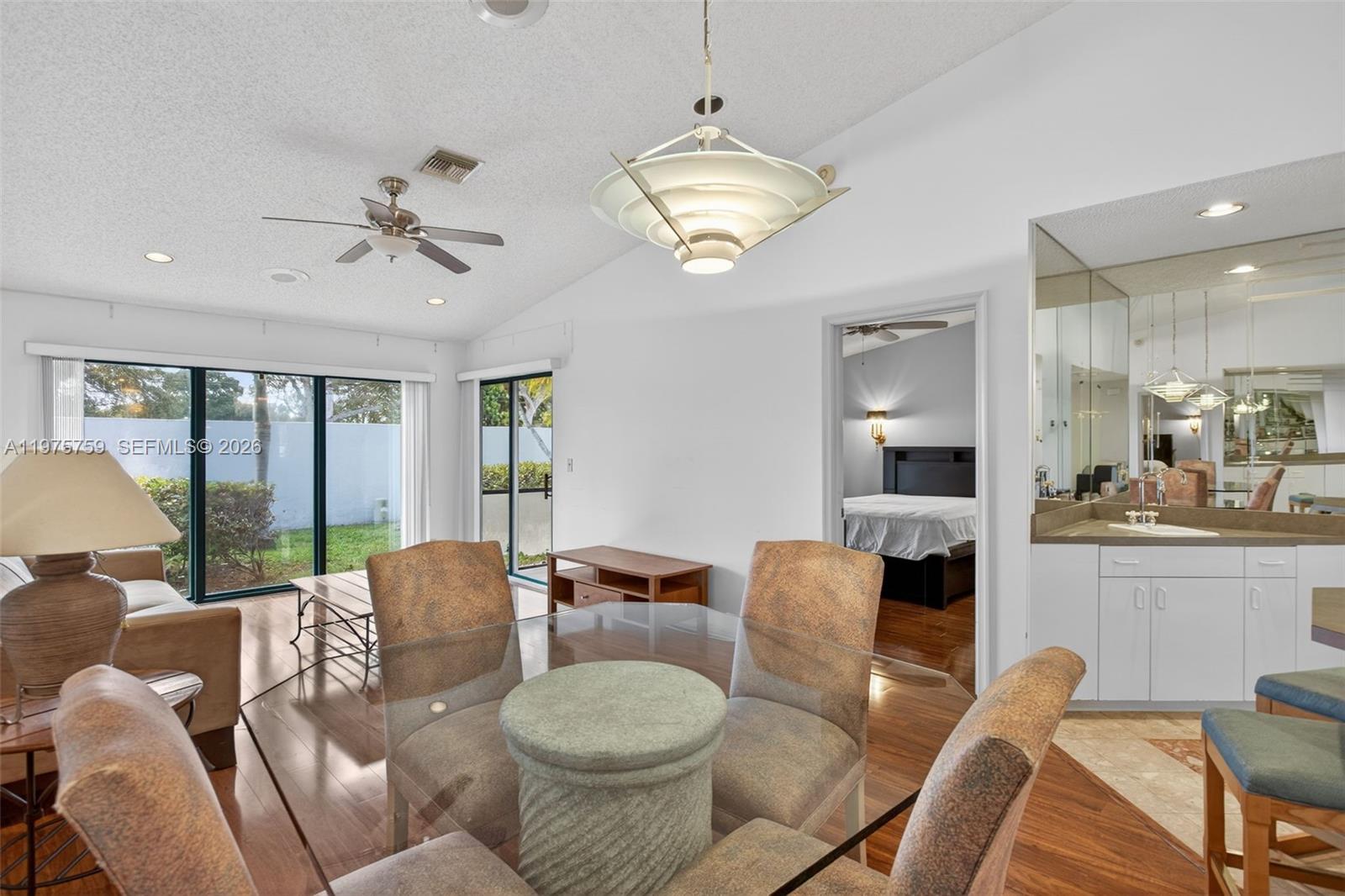 6708 North Pine Island Road Tamarac, FL 33321 - Photo 7 of 40 a view of a dining room with furniture a chandelier and window