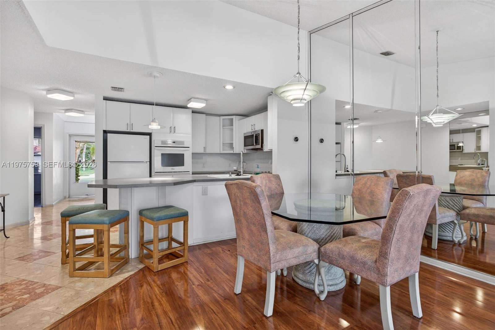 6708 North Pine Island Road Tamarac, FL 33321 - Photo 8 of 40 a view of a dining room with furniture wooden floor and chandelier