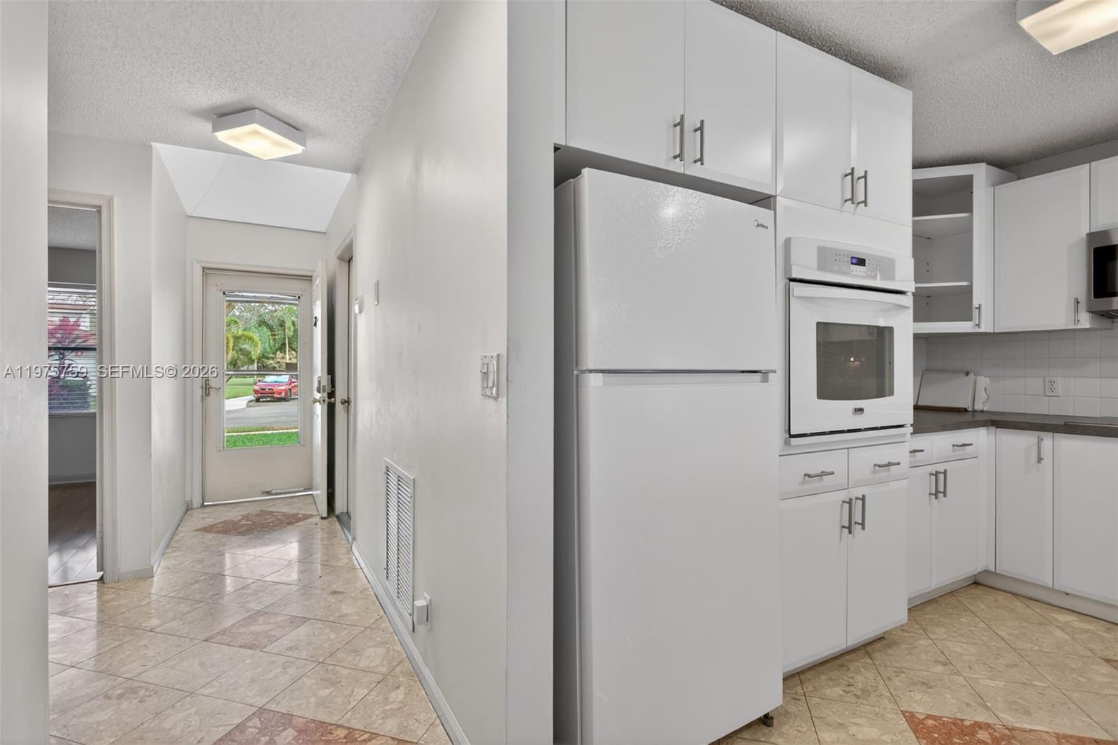 6708 North Pine Island Road Tamarac, FL 33321 - Photo 10 of 40 a view of a hallway with wooden cabinets