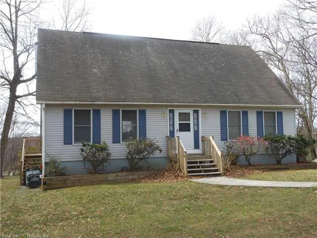 a front view of house with yard and outdoor seating