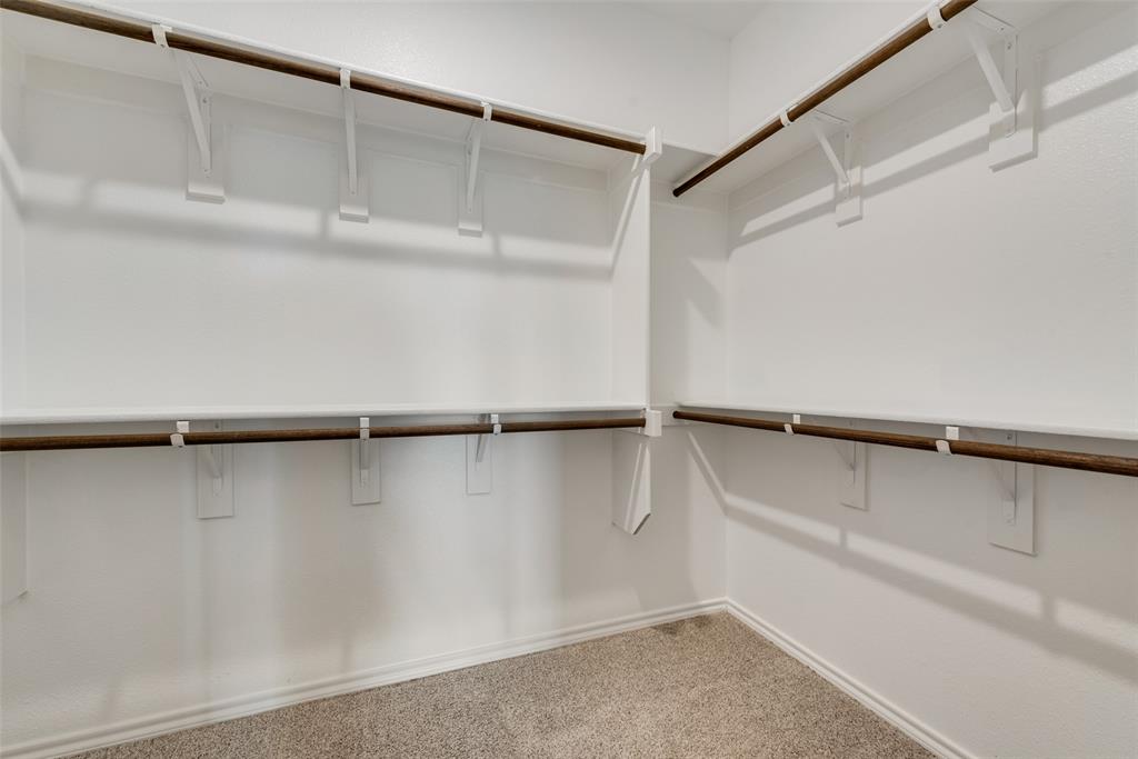 1428 Millstead Rill Drive Caddo Mills, TX 75135 - Photo 16 of 24 a view of walk in closet with empty racks