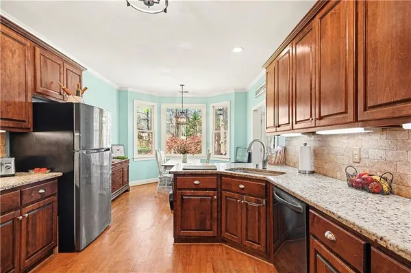 a kitchen with stainless steel appliances granite countertop a sink stove and refrigerator