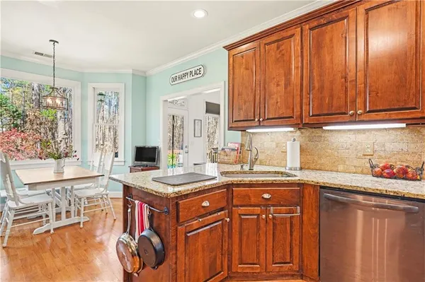 a kitchen with stainless steel appliances granite countertop a sink and cabinets