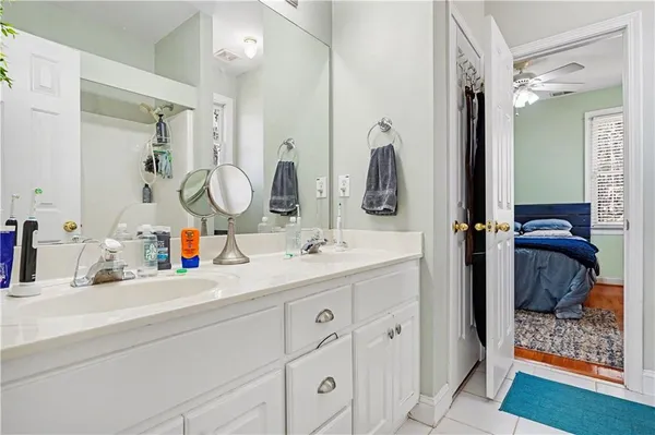 a bathroom with double vanity sinks and a mirror