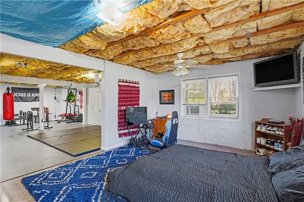 a bedroom with furniture and flat screen tv