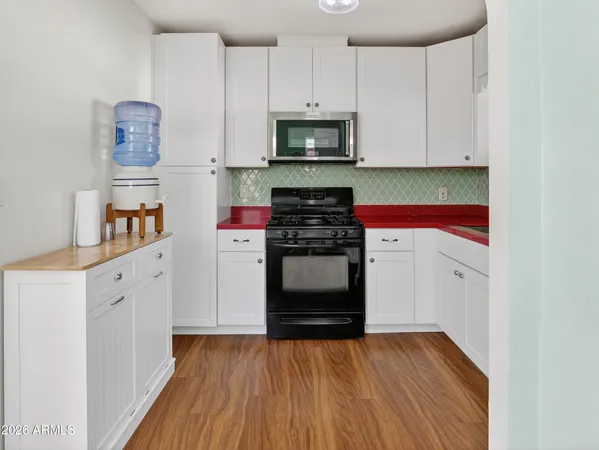 a view of a dining room with furniture and a chandelier fan