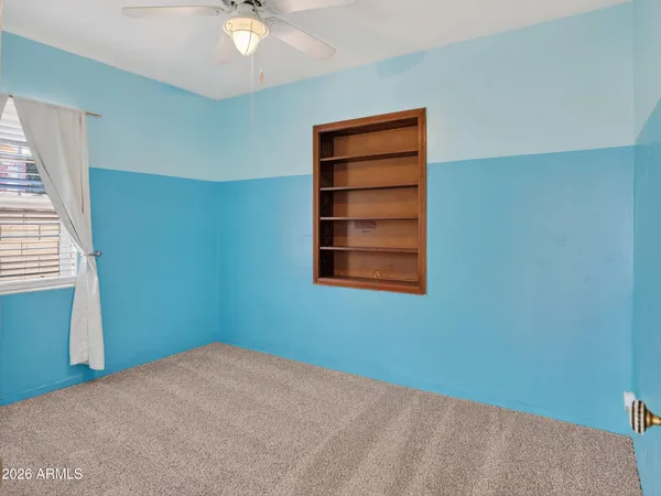an empty room with wooden floor and closet