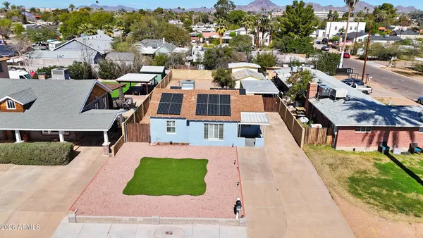 an aerial view of a house with garden space and street view