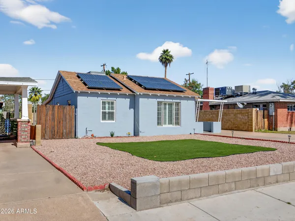 an aerial view of a house with yard