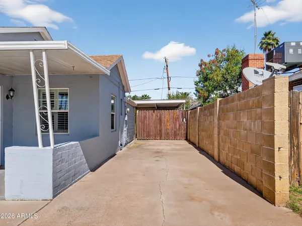 a front view of a house with a yard and potted plants