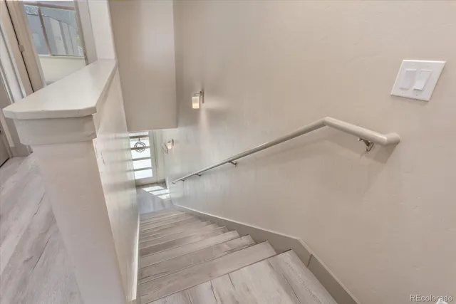 a view of a room with wooden floor and staircase