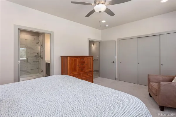 a bedroom with a large bed and a chandelier