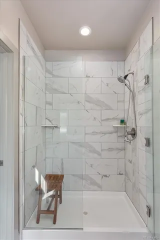a bathroom with a shower and a bath tub