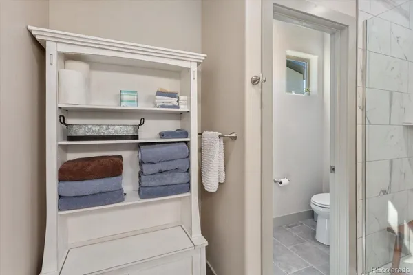 a view of bathroom with a toilet a sink and a mirror