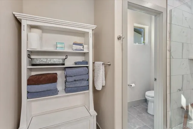 a view of bathroom with a toilet a sink and a mirror
