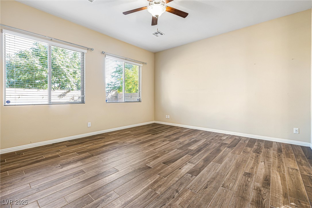 60 Newton Ridge Way Las Vegas, NV 89183 - Photo 14 of 44 Unfurnished room with dark wood-type flooring and ceiling fan