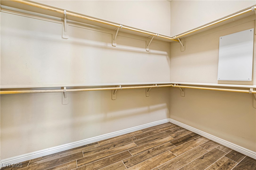 60 Newton Ridge Way Las Vegas, NV 89183 - Photo 20 of 44 Walk in closet with wood tiled floors