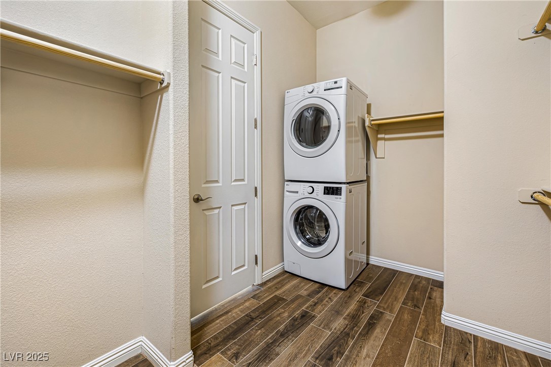 60 Newton Ridge Way Las Vegas, NV 89183 - Photo 21 of 44 Laundry area featuring wood finish floors and stacked washer / drying machine