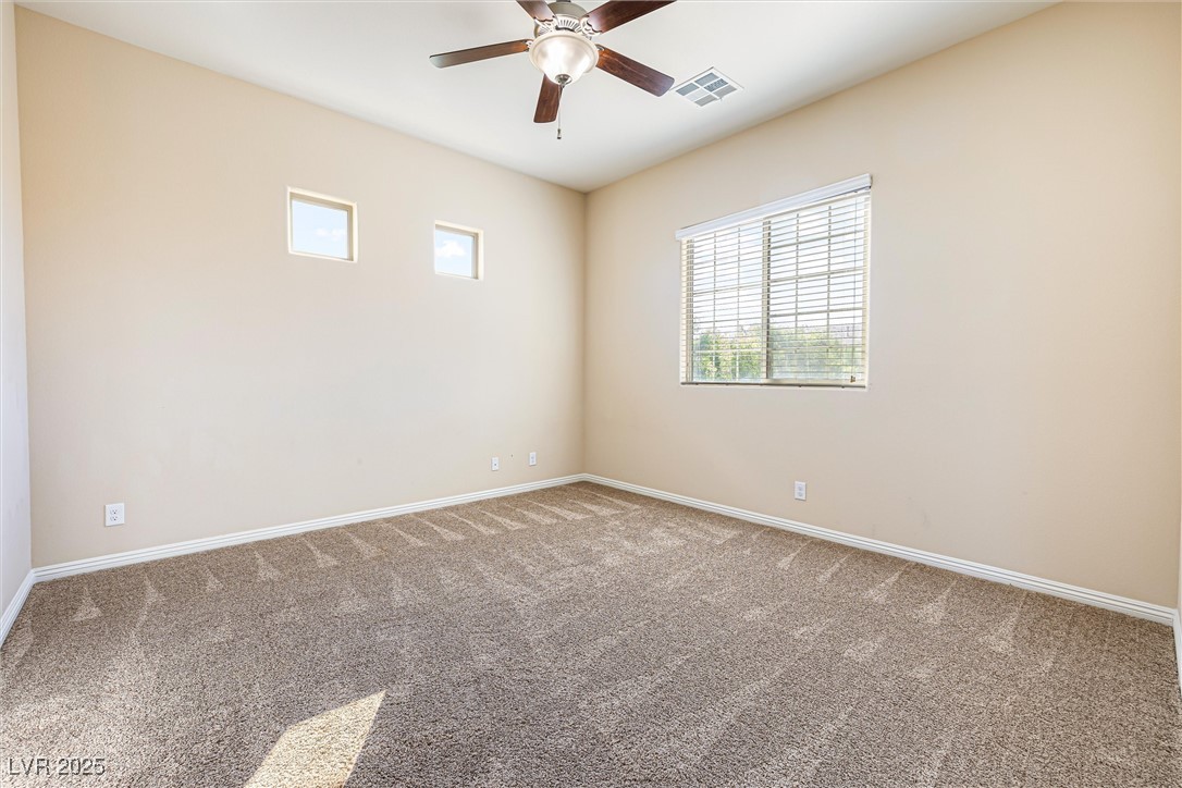 60 Newton Ridge Way Las Vegas, NV 89183 - Photo 23 of 44 Empty room featuring carpet flooring and ceiling fan